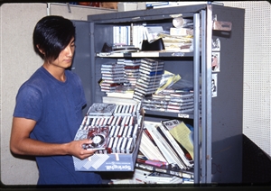 1987 WRSU Orientation Slide Show<br/>Production Team sorting carts in Production<br>Slide #28