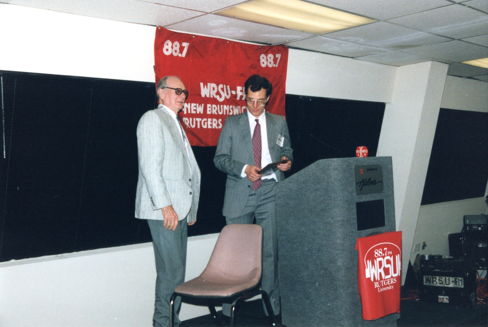 Daniel Schleck giving Charles Brookwell a plaque to commemorate WRSU s beginning.